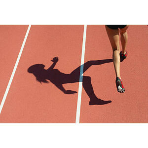 Umělecká fotografie Female athlete running on track, low, PhotoAlto/Odilon Dimier, (40 x 26.7 cm)