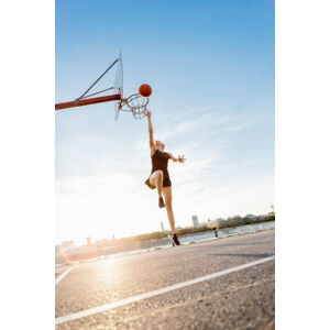 Umělecká fotografie Blonde woman playing basketball in Cologne,, Westend61, (26.7 x 40 cm)