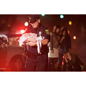Umělecká fotografie Police officer rescuing a baby, Image Source, (40 x 26.7 cm)