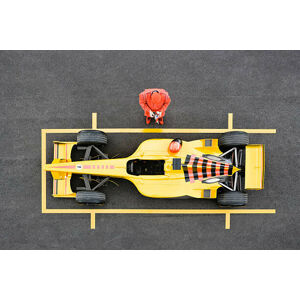 Umělecká fotografie Racecar Driver Standing by Racecar Adjusting, David Madison, (40 x 26.7 cm)
