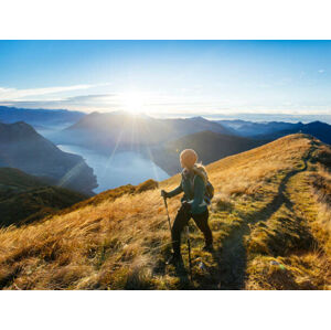 Umělecká fotografie Woman hikes along ridgecrest above lake, valley, Milo Zanecchia/ Ascent Xmedia, (40 x 30 cm)