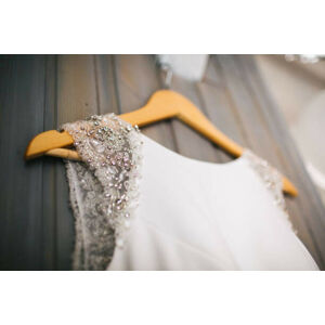 Umělecká fotografie Elegant wedding dress hanging on gray wall, JovanaT, (40 x 26.7 cm)